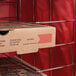 An American Metalcraft pizza delivery bag holding a pizza box on a shelf.