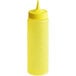 A yellow plastic Vollrath Color-Mate squeeze bottle with a pointy tip lid.