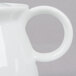 A white Arcoroc teapot with a handle and a lid.
