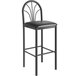 A Lancaster Table & Seating Spoke Back Bar Stool with a black vinyl seat on a white background.