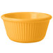 A yellow fluted ramekin on a white background.