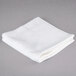 An Oxford Platinum white wash cloth with a dobby twill border on a gray surface.
