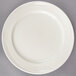 A Oneida Espree cream white china plate with a circular rim.