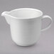 A Oneida Botticelli bright white porcelain creamer with a white handle.