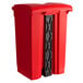 A red rectangular step-on trash can with a black lid.