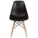 A black plastic Flash Furniture side chair with wooden legs.