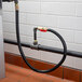 A black hose attached to a pipe.