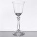 A clear glass wine glass with a stem.