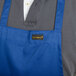 A man wearing a Chef Revival royal blue bib apron with one pocket.