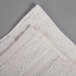 An Oxford Vicenza Avorio white wash cloth with a white dobby border.