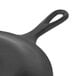 A Lodge black pre-seasoned cast iron skillet with a handle.