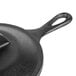 A close-up of a Lodge mini cast iron skillet with a cover.