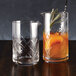 Two American Metalcraft diamond cut stirring glasses with cocktails in them.