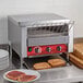 An Avantco conveyor toaster with toast on the counter.