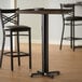 A Lancaster Table & Seating black bar height table base.