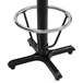 A black metal bar height table base with a foot ring and flat table levelers.
