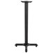 A black Lancaster Table & Seating bar height table base column with flat tech levelers.