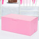 A pink bakery box on a table.