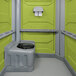 A wheelchair accessible lime green PolyJohn portable restroom.