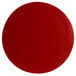 A red round disc with a textured finish on a white background.