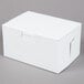 A 5 1/2" x 4" x 3" white cake / bakery box with a lid.