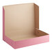 A pink Baker's Mark bakery box with a lid.