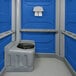 A PolyJohn wheelchair accessible portable restroom with a blue interior.