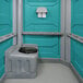 A PolyJohn wheelchair accessible portable restroom with a black toilet seat.