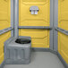 A yellow PolyJohn wheelchair accessible portable restroom.