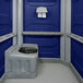 A dark blue PolyJohn wheelchair accessible portable restroom.