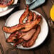 A plate of Kunzler Black Forest bacon with a glass of orange juice.