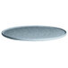 A G.E.T. Enterprises Bugambilia sky blue granite medium round disc with rim on a table.