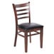 A Lancaster Table & Seating mahogany wood ladder back chair with black vinyl seat detached.