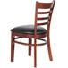 A Lancaster Table & Seating mahogany wood ladder back chair with black vinyl seat