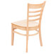 A Lancaster Table & Seating natural wood chair with a ladder back and natural wood seat.