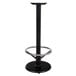 A Lancaster Table & Seating black cast iron bar height table base with a round metal foot ring.