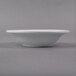 A close up of a Libbey bright white porcelain fruit bowl with black constellation lines on the outside.