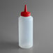 A white plastic bottle with a red lid.