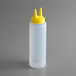 A white plastic cylinder with yellow plastic cone-shaped tips.