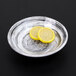An Elite Global Solutions round black melamine bowl with lemon slices inside.