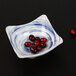 An Elite Global Solutions square melamine bowl with a blue and white Van Gogh pattern filled with cranberries.