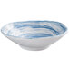 An oval blue bowl with a swirl design in white.