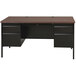 A black Hirsh Industries double pedestal desk with drawers and a walnut top.
