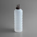 A clear plastic Vollrath squeeze bottle with a brown cap.