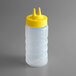 A Vollrath Traex plastic squeeze bottle with a yellow Twin Tip lid.