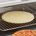 An American Metalcraft pizza stone cooking a pizza in an oven.