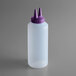 A white plastic bottle with a purple Twin Tip lid.
