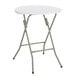 A white round Lancaster Table & Seating plastic folding table with a metal frame.