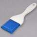 A blue Carlisle Sparta Spectrum pastry brush with a white handle.