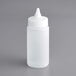 A white plastic Vollrath squeeze bottle with a pointed tip and a lid.